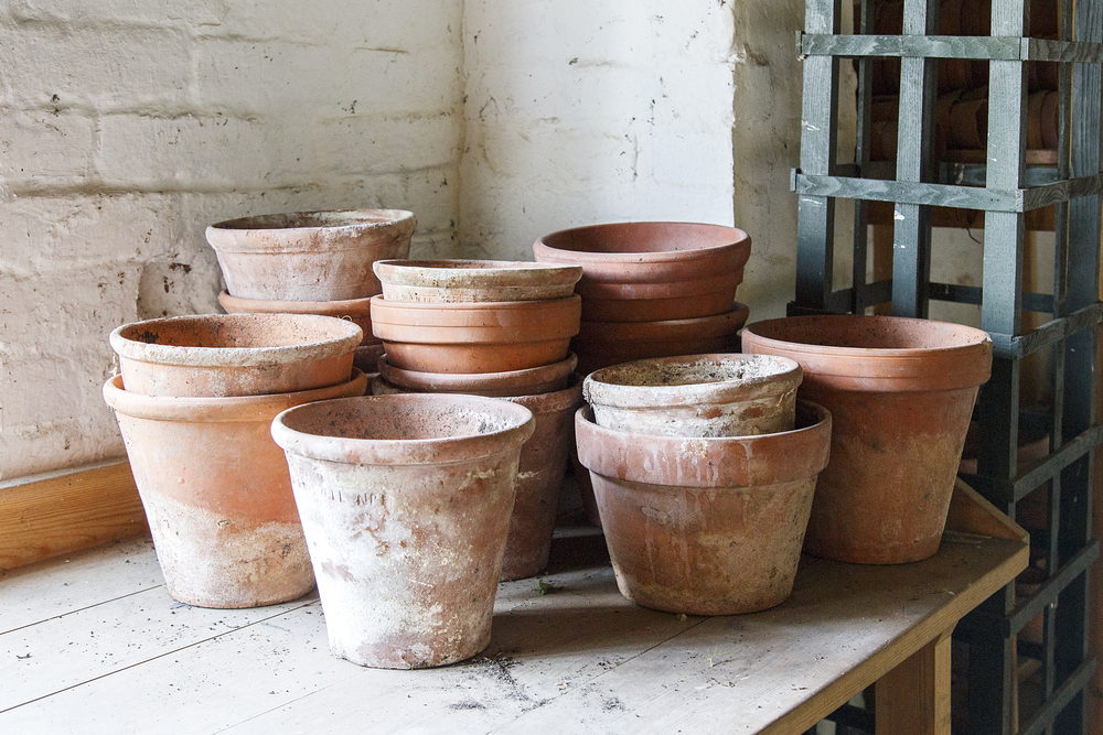 stacks of clay pots on an outdoor table