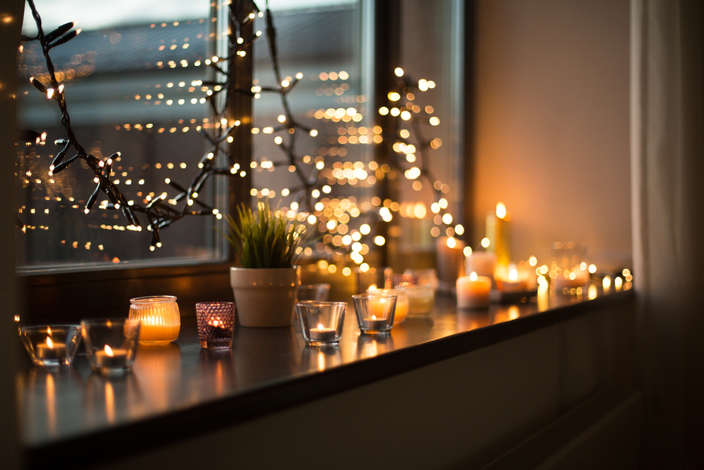 candles and string lights in a window