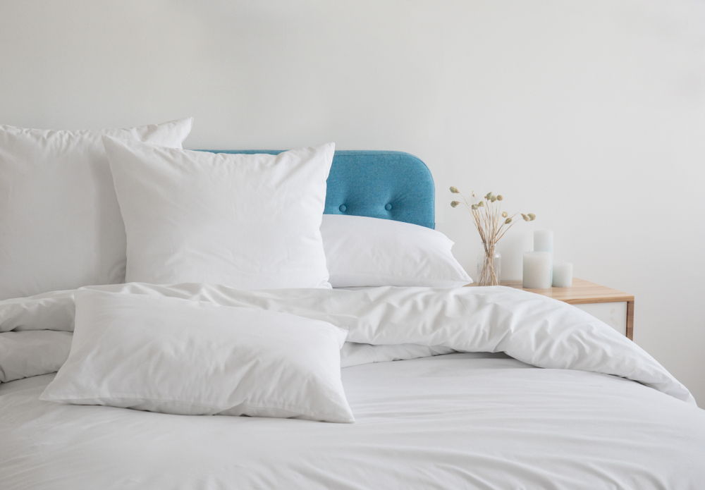 bed with white fluffy pillows and bedding