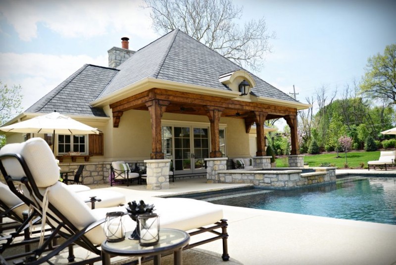 Pool house design with rustic timber columns and stucco finish