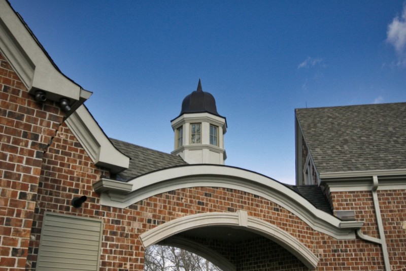 Brick and stone arched entry of motor court