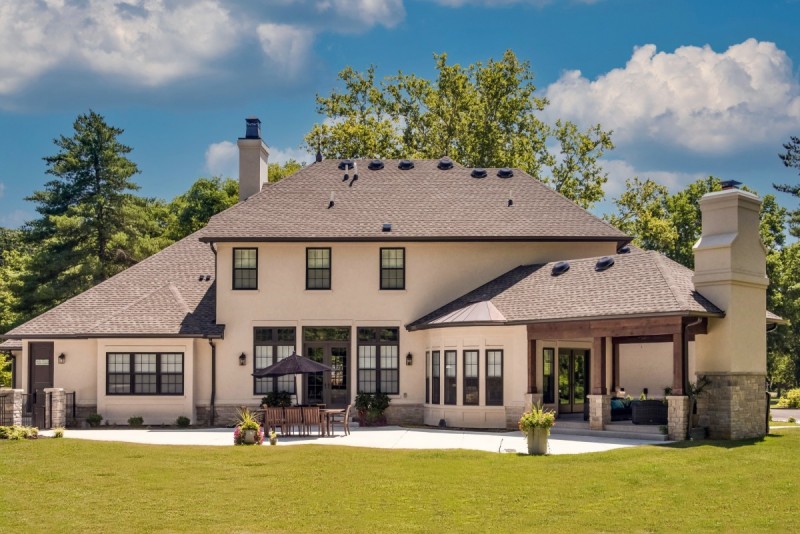 french country home with stone stucco