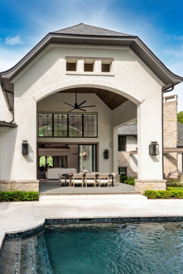 home design covered patio dining with towering ceiling