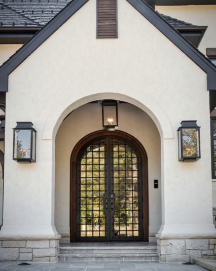 Wood front entry door with stucco and stone exterior