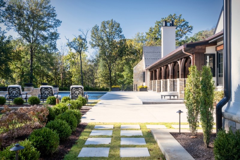 Spaced paver walkway leading to pool deck and patio