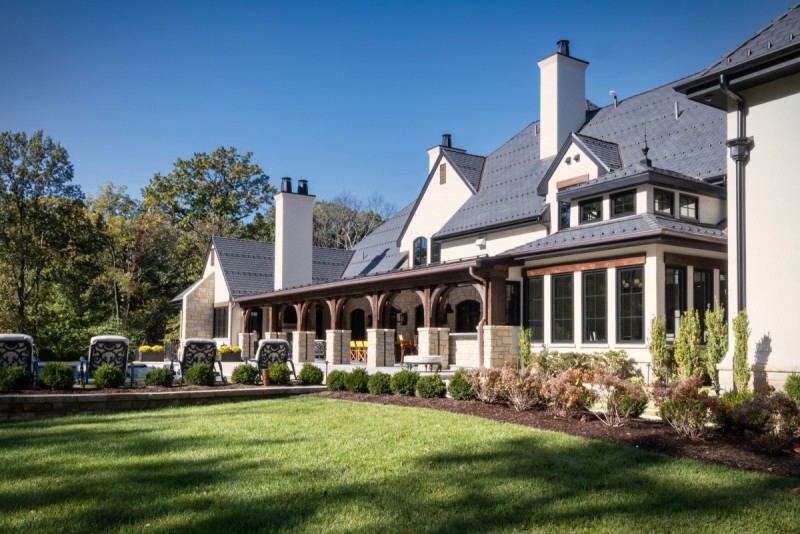 Beige stucco siding exterior mediterranean with dark roof