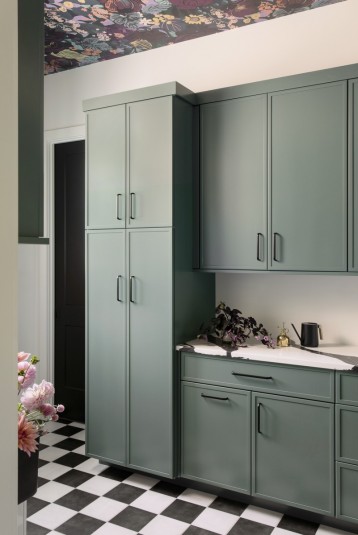 laundry room design with teal cabinets