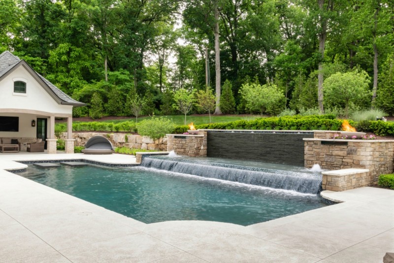 waterfall pool deck of french country home design