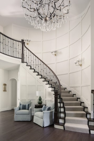 winding staircase design with board and batten accent wall