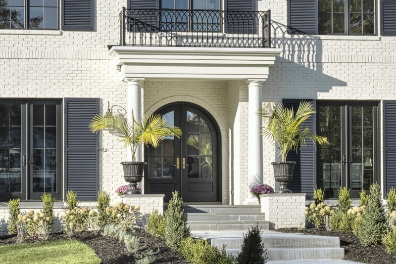 georgian style home with balcony portico entry
